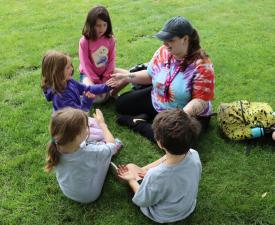 Students and camp leader in a circle.